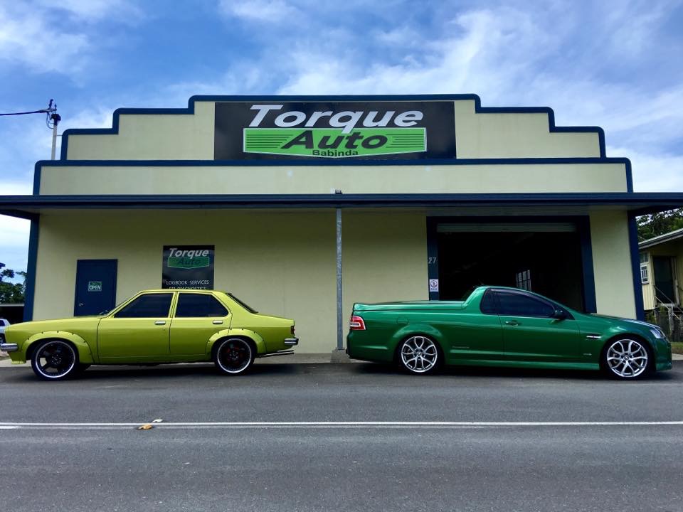 Two cars parked outside the Torque Auto Babinda workshop under the Torque Auto sign