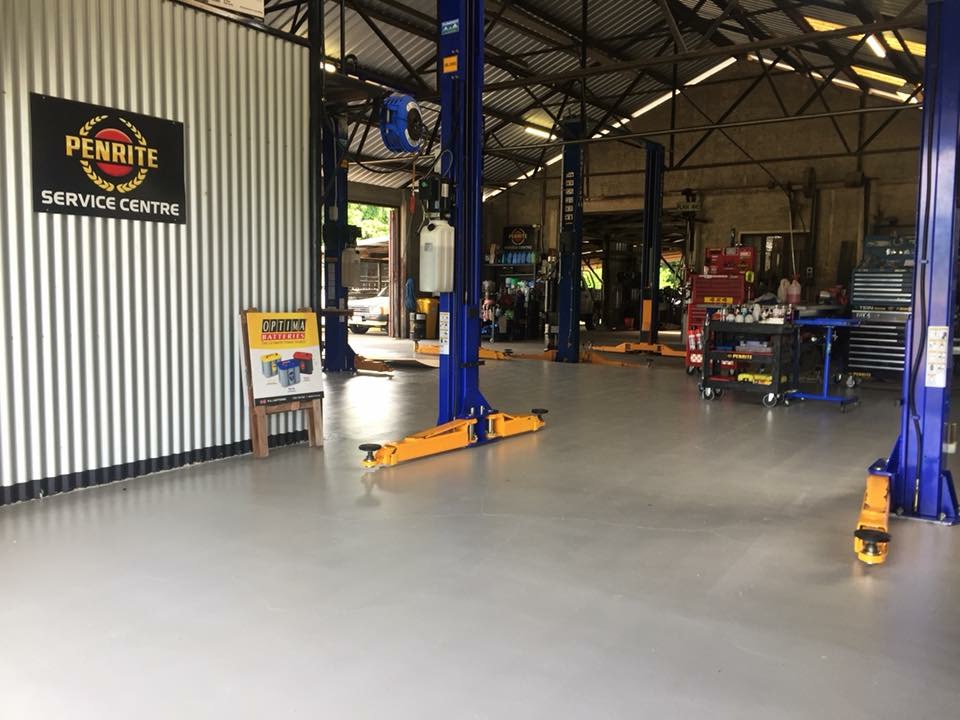 The full length of the Torque Auto Babinda workshop with three hoists, tool chests and the Penrite service centre sign