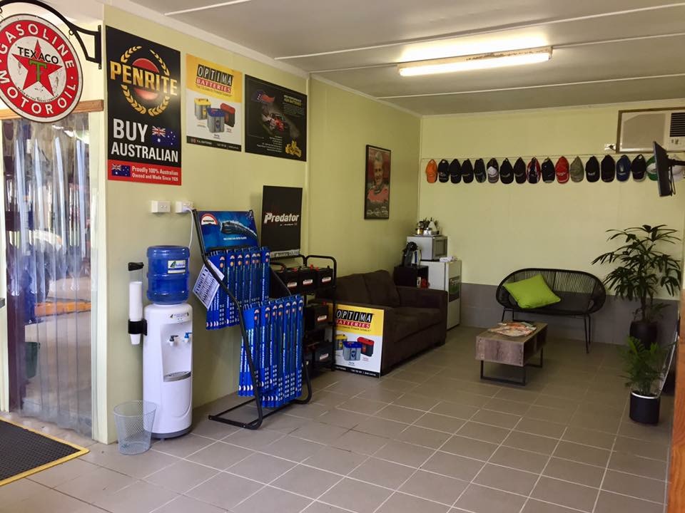 The Torque Auto Babinda customer waiting area, with seating, a water cooler and battery displays