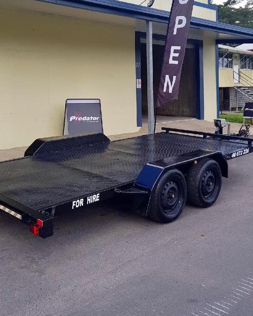 The Torque Auto Babinda tandem axle car trailer, marked for hire, parked in front of the workshop