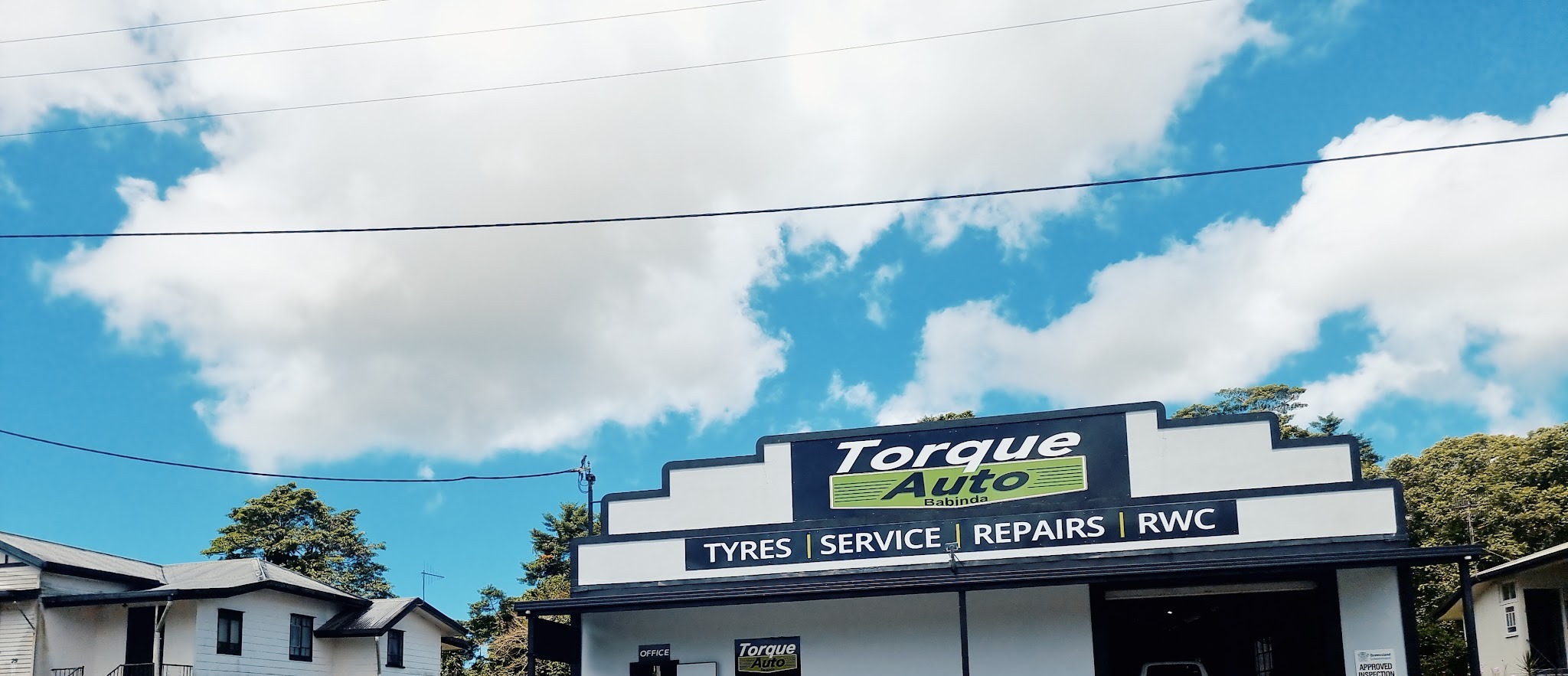 The Torque Auto Babinda shopfront, with the fascia reading tyres, service, repairs and RWC, and the Queensland Approved Inspection Station notice on the wall